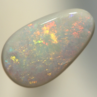 SOLID SEMI BLACK OPAL Orange and green move gently over a medium dome